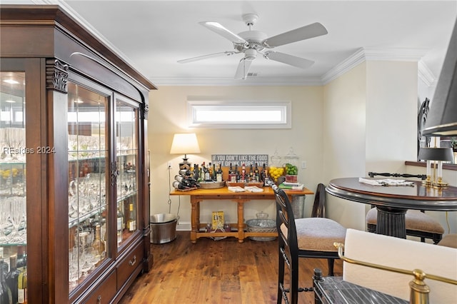 interior space featuring dark wood-type flooring, ornamental molding, and ceiling fan