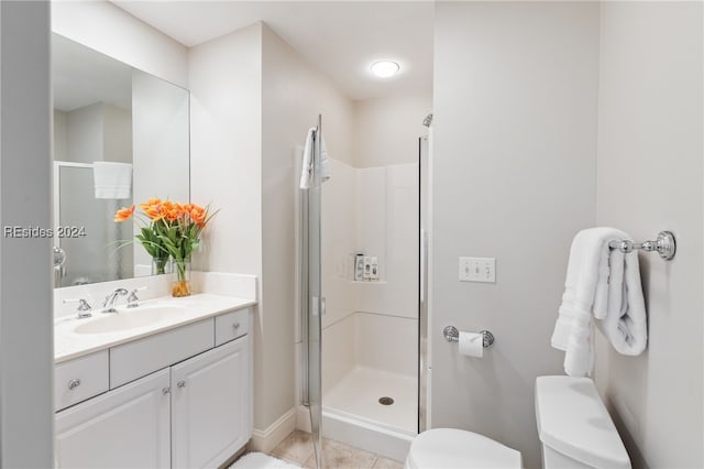 bathroom with walk in shower, tile patterned floors, vanity, and toilet