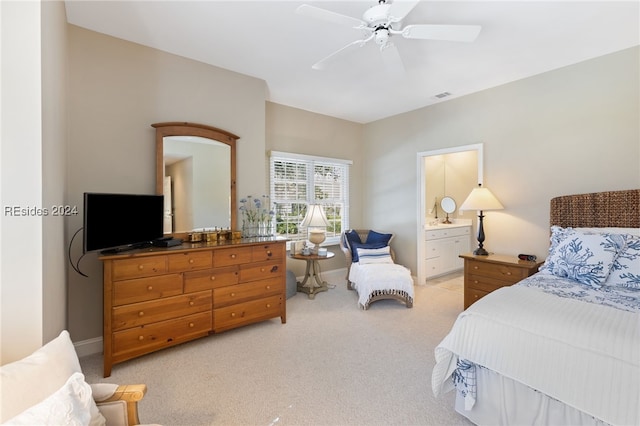 carpeted bedroom with ceiling fan and ensuite bathroom