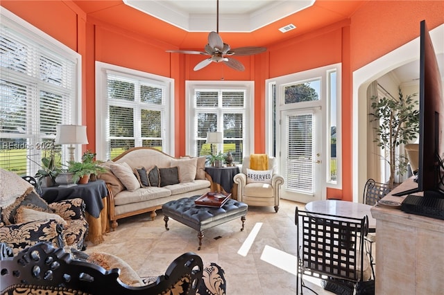 sunroom / solarium featuring ceiling fan and a tray ceiling