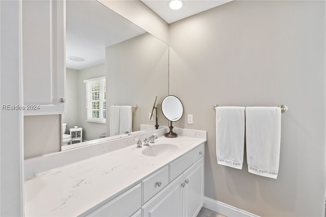 bathroom featuring vanity and toilet