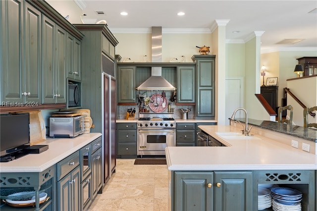 kitchen with premium stove, sink, kitchen peninsula, crown molding, and wall chimney exhaust hood