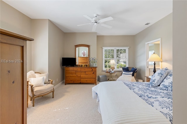 bedroom with light carpet and ceiling fan