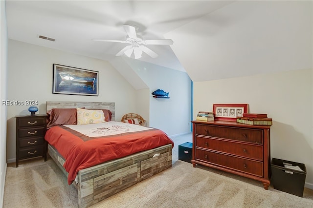 carpeted bedroom with ceiling fan and vaulted ceiling