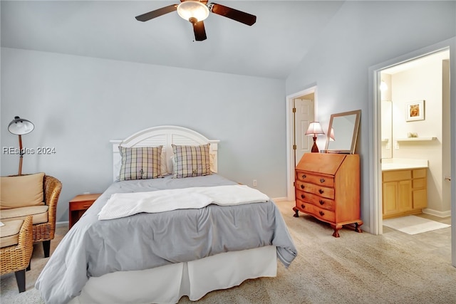 carpeted bedroom featuring ceiling fan, ensuite bath, and lofted ceiling