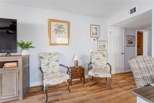 sitting room featuring light hardwood / wood-style flooring