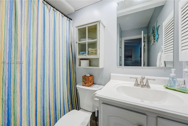 bathroom featuring vanity, ornamental molding, and toilet