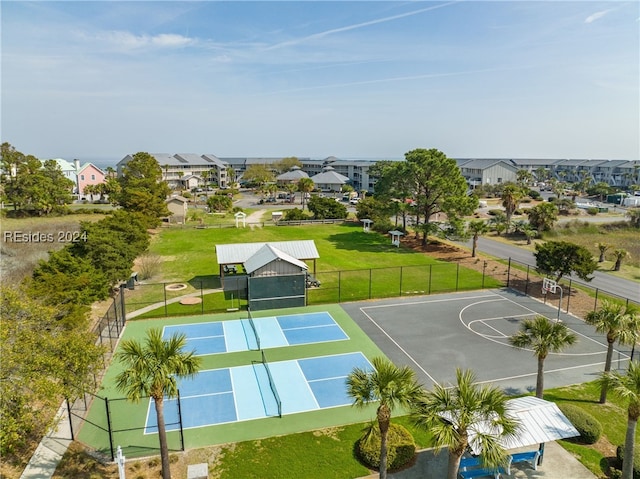 view of basketball court with a yard