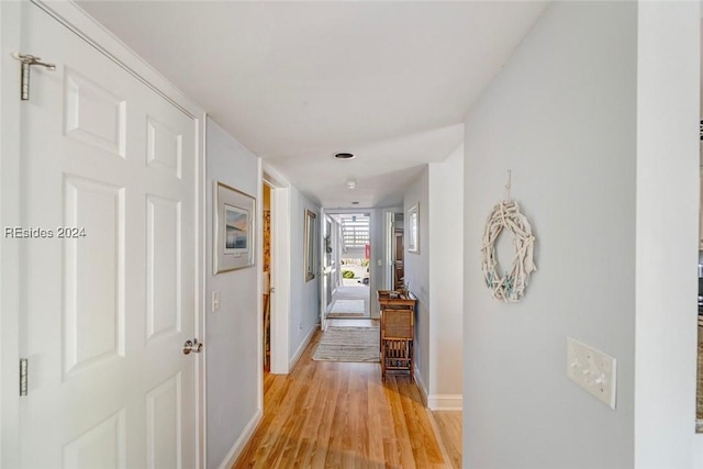 hallway with light hardwood / wood-style flooring