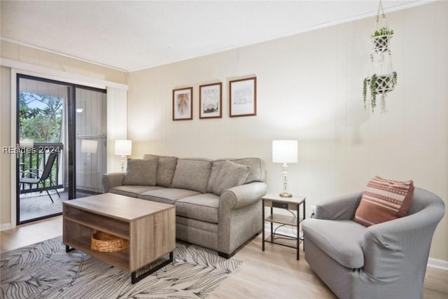 living room with ornamental molding and light hardwood / wood-style floors