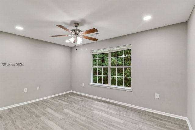 spare room featuring ceiling fan and light hardwood / wood-style flooring