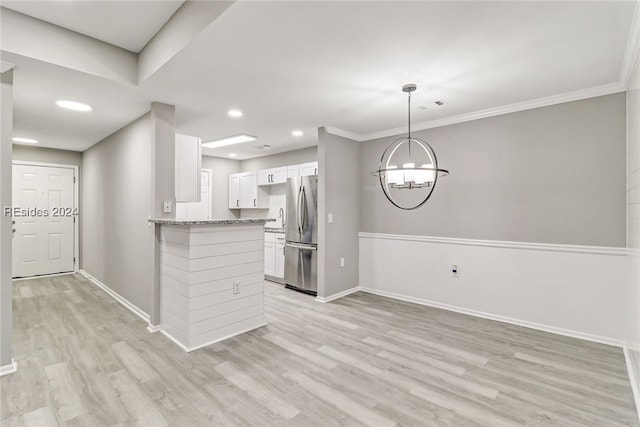 kitchen featuring white cabinetry, stainless steel fridge, kitchen peninsula, and light wood-type flooring