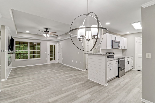 kitchen with light wood-type flooring, pendant lighting, stainless steel appliances, light stone countertops, and white cabinets