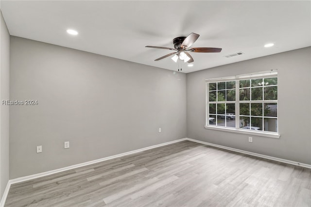 unfurnished room with ceiling fan and light hardwood / wood-style floors