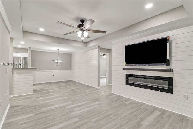 unfurnished living room featuring crown molding, ceiling fan, and light wood-type flooring