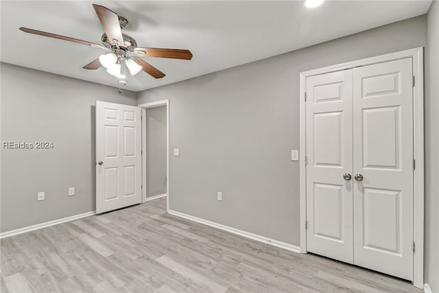 unfurnished bedroom with ceiling fan, a closet, and light hardwood / wood-style flooring