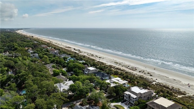 drone / aerial view with a water view and a beach view