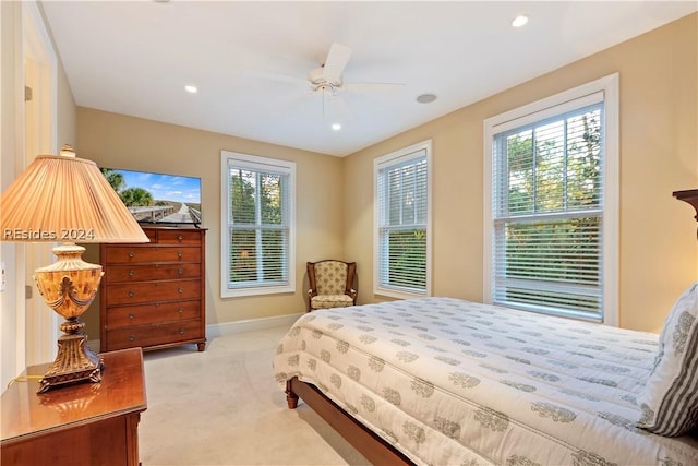 bedroom with light colored carpet and ceiling fan