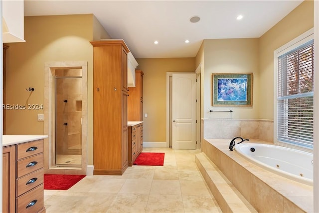 bathroom with vanity, tile patterned floors, and separate shower and tub