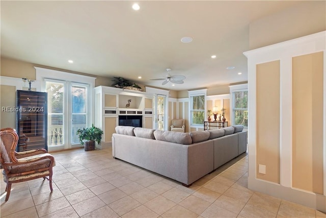 living room featuring light tile patterned flooring and ceiling fan