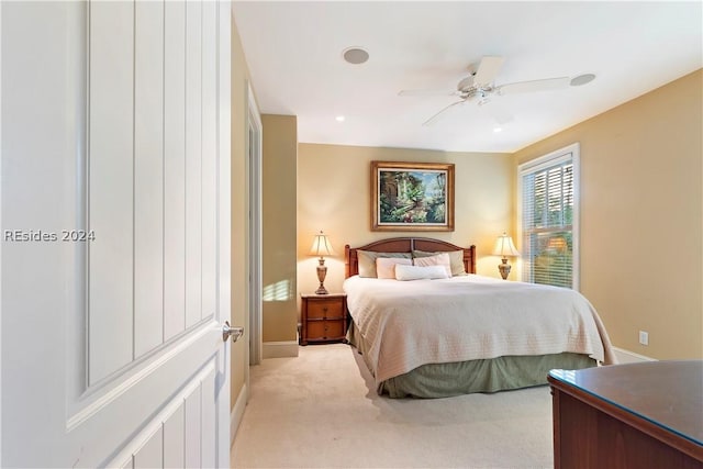 bedroom featuring light carpet and ceiling fan