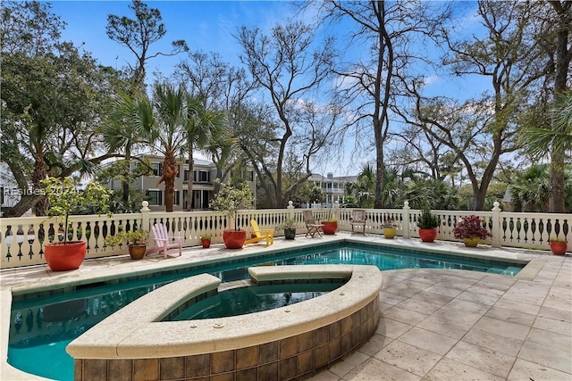 view of pool with an in ground hot tub