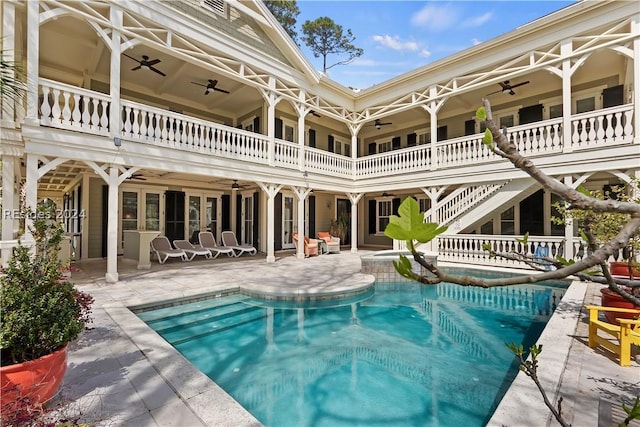 view of swimming pool featuring a patio and ceiling fan