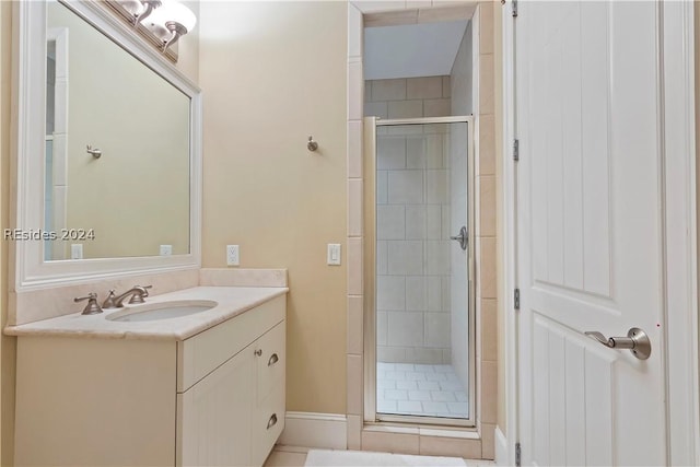 bathroom featuring an enclosed shower and vanity