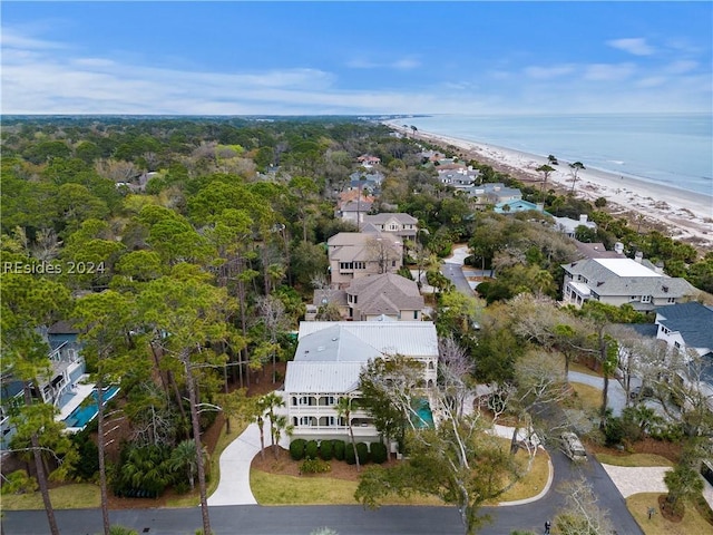 aerial view with a water view and a beach view