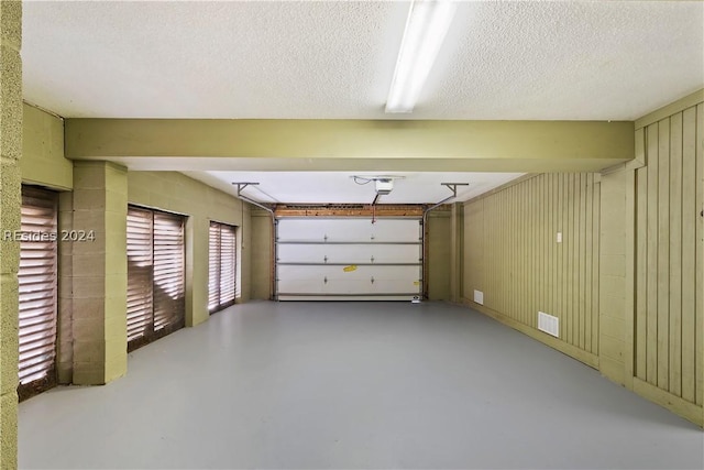 garage featuring wooden walls