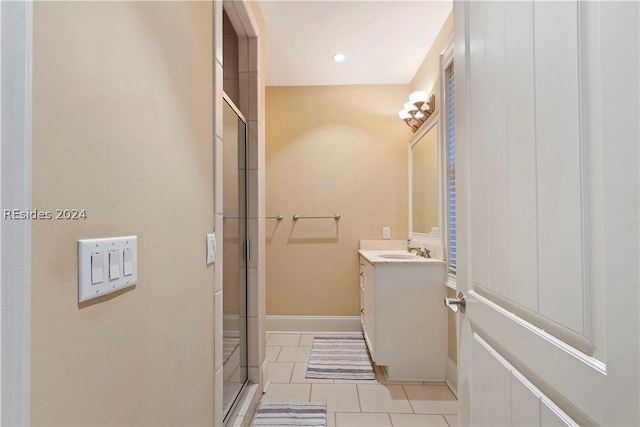 bathroom with tile patterned floors, an enclosed shower, and vanity