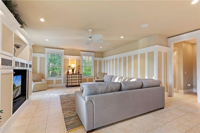 living room featuring light tile patterned flooring and ceiling fan