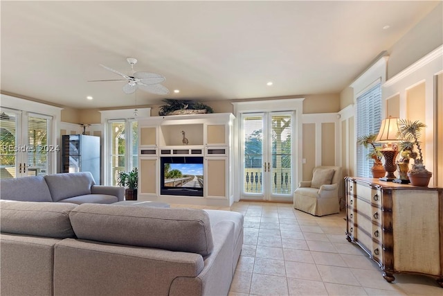 living room with french doors, ceiling fan, and light tile patterned flooring