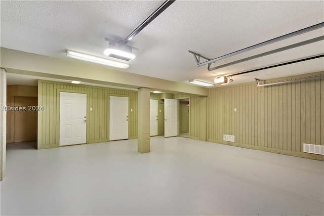 garage featuring wood walls