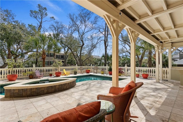 view of patio / terrace with a pool with hot tub