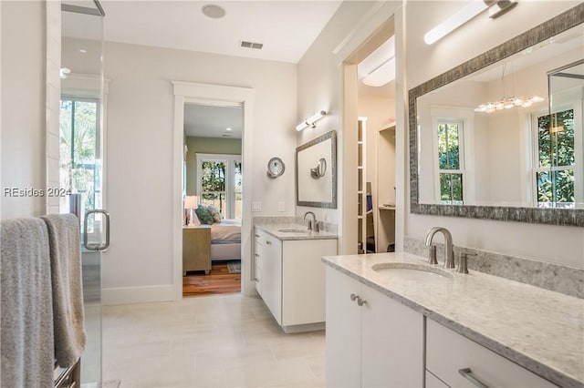 bathroom featuring vanity, tile patterned flooring, and a wealth of natural light