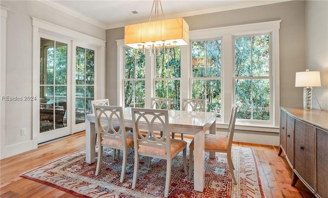 sunroom / solarium featuring a chandelier