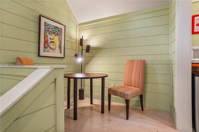 sitting room with lofted ceiling and light hardwood / wood-style flooring