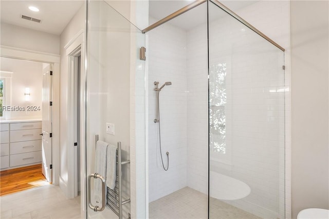 bathroom with vanity and a shower with shower door