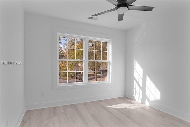 unfurnished room with ceiling fan and light wood-type flooring