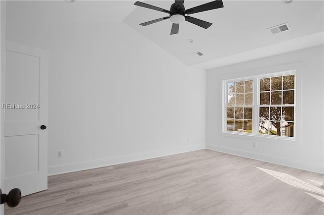 unfurnished room with lofted ceiling, ceiling fan, and light hardwood / wood-style flooring