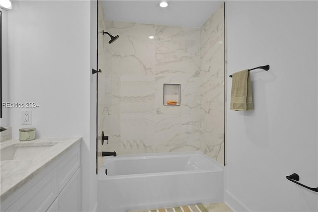 bathroom with vanity and tiled shower / bath combo