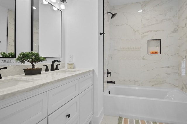 bathroom featuring vanity and tiled shower / bath