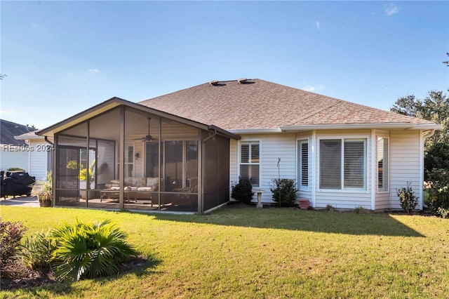 rear view of property with a sunroom and a lawn