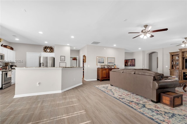 living room featuring light hardwood / wood-style floors and ceiling fan