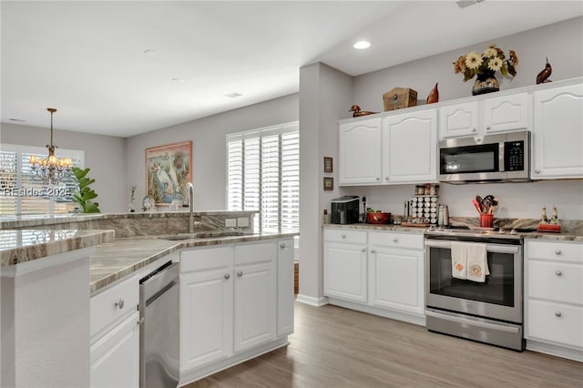 kitchen with white cabinetry, stainless steel appliances, and sink