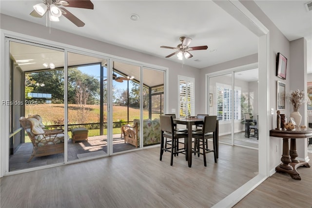 sunroom featuring ceiling fan