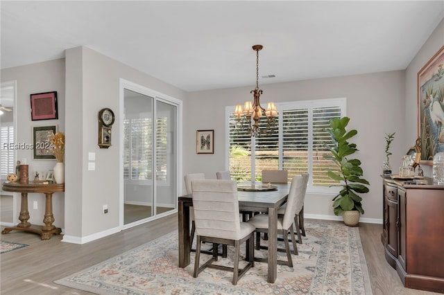 dining space featuring a chandelier and light hardwood / wood-style flooring