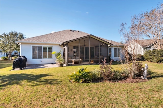 back of property with a sunroom and a lawn