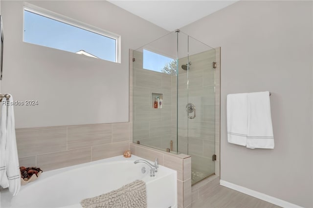 bathroom with separate shower and tub